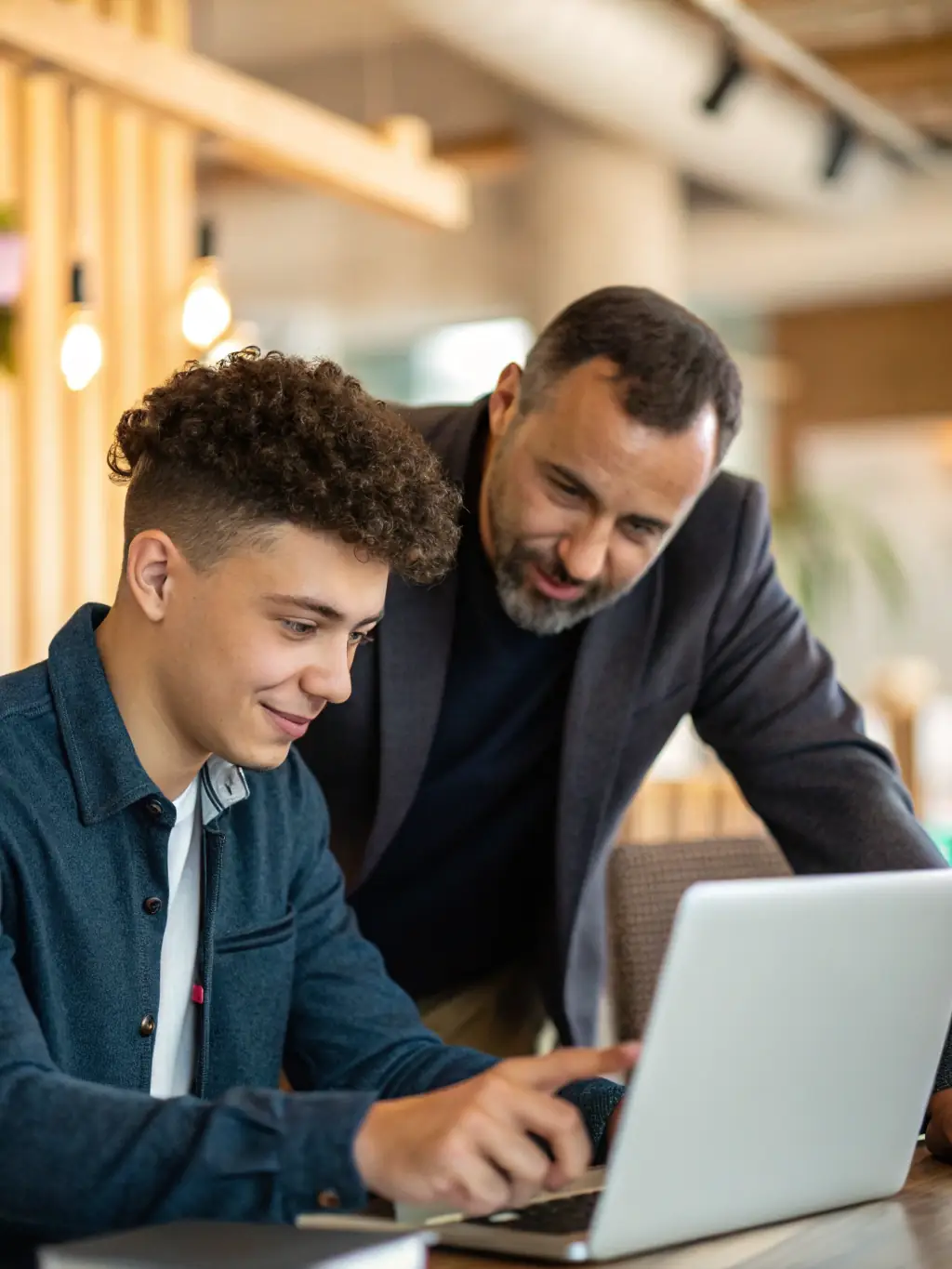 A small business owner is receiving personalized advice from a business mentor in a co-working space, with a supportive and collaborative atmosphere.